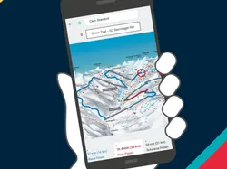 Smartphone displaying interactive ski resort map with trail information in hand