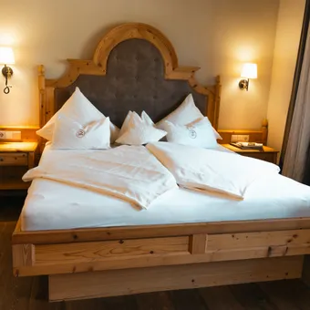 Cozy hotel room with wooden double bed, nightstands and warm lighting