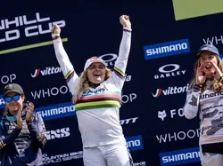 Female mountain bikers celebrating on the podium at a Downhill World Cup event