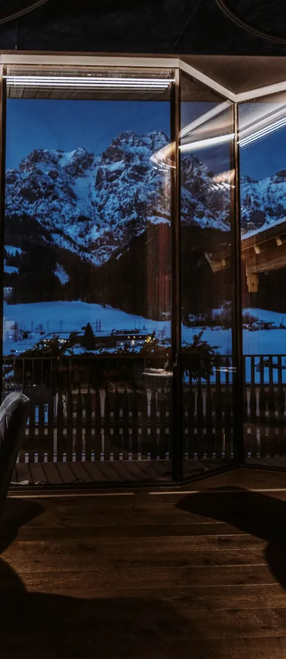 Elegant mountain view restaurant with round tables set for fine dining