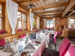 Cozy alpine-style restaurant with wooden interior and neatly set dining tables