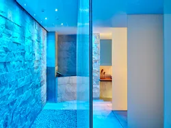 Modern spa interior with stone walls, ambient lighting, and water feature