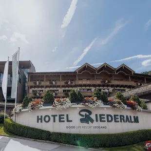 Hotel Riederalm in Leogang with alpine wooden architecture and flower-decorated balconies