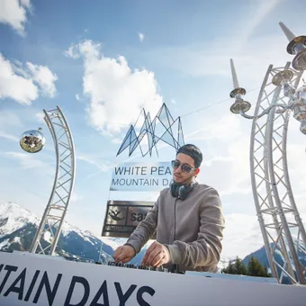 DJ performing at White Pearl Mountain Days festival in snowy alpine outdoor setting