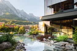 Modern spa resort with kneipp basin and mountain view in alpine landscape