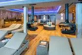 Modern spa lounge with cozy loungers, round sofas, fireplaces and ambient lighting