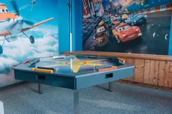 Children’s playroom with Cars and Planes movie murals and interactive game table